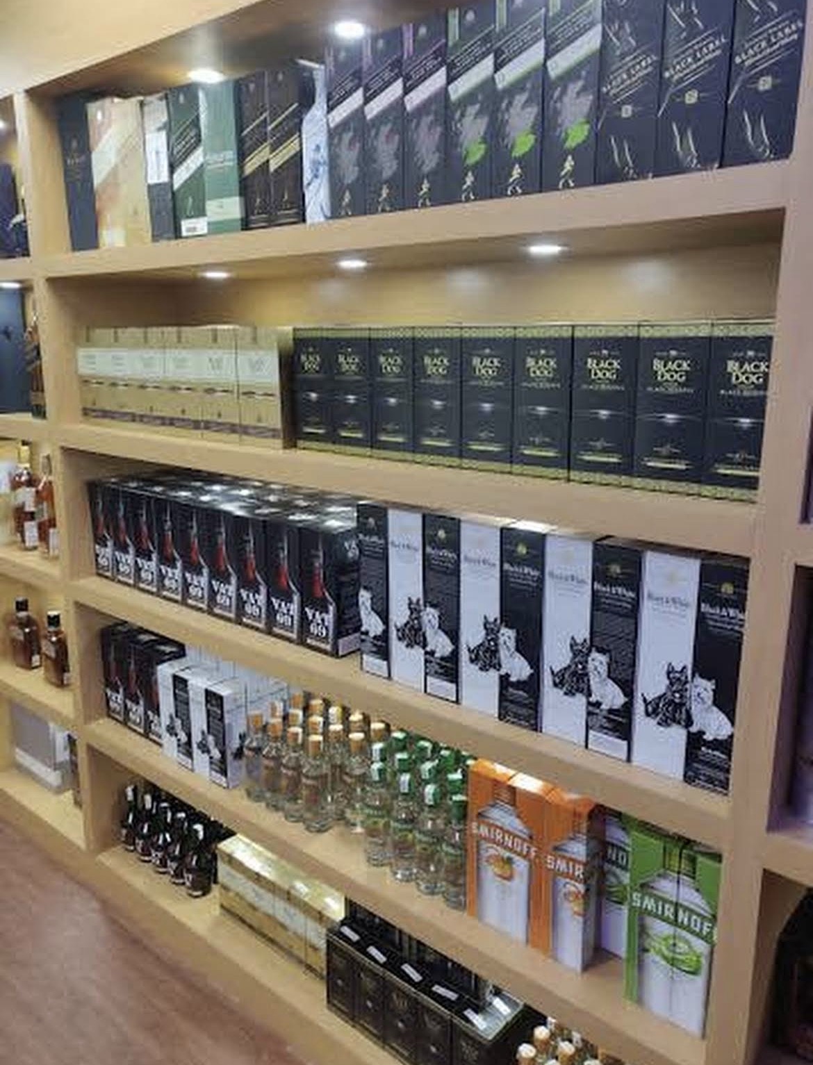 Premium vodka, rum, gin, and tequila bottles at Vandyk Spirits Noida retail theka