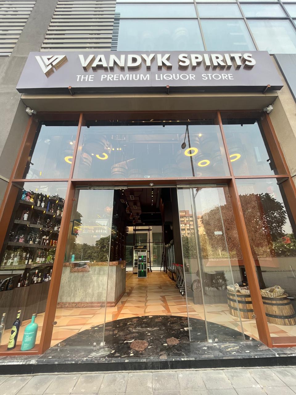 Inside Vandyk Spirits Noida showing organized alcohol display and expert staff