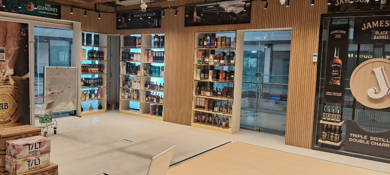 Luxury retail theka with organized alcohol shelves and fine decor