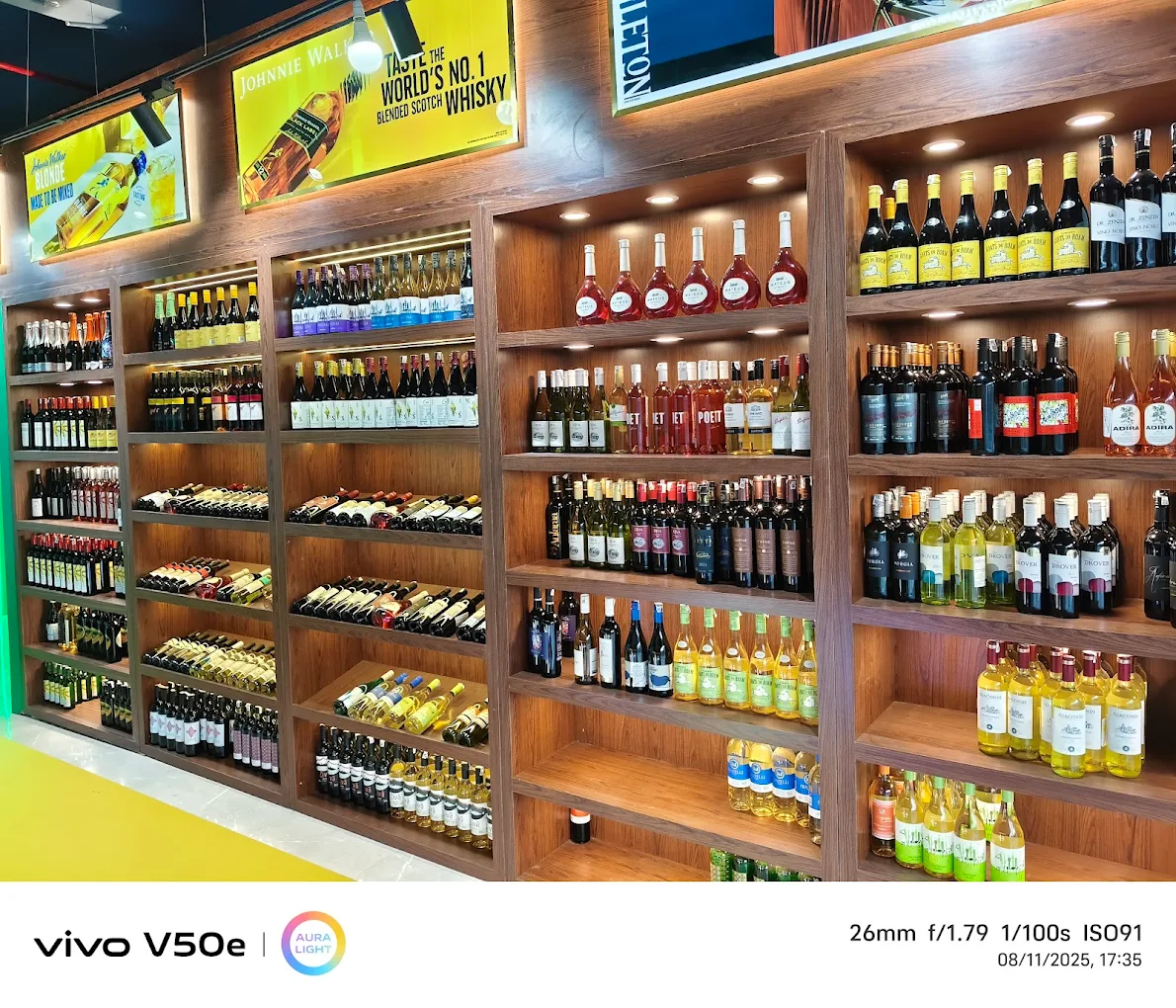 Air-conditioned liquor store with organized alcohol display at Whisky Junction Noida