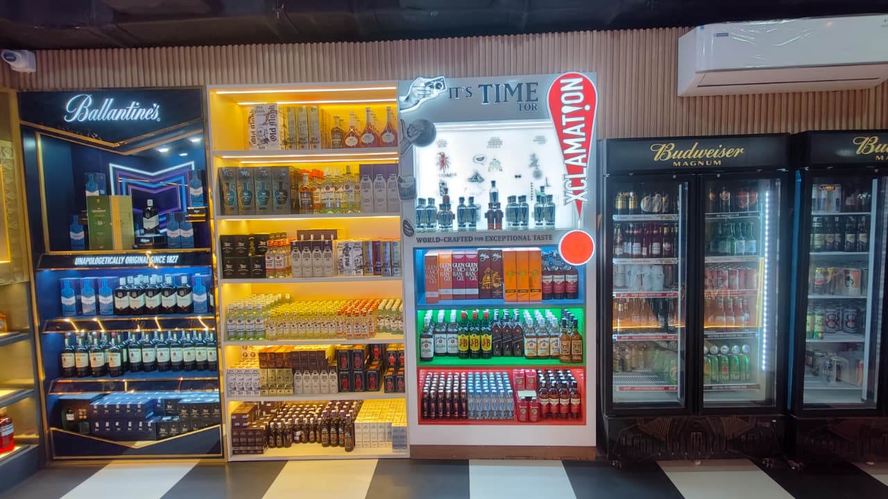Modern liquor store interior with neatly arranged inventory and price tags.