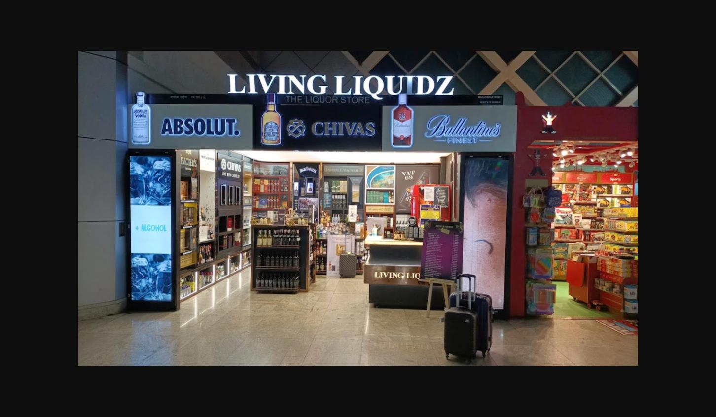 Living Liquidz CSMIA T1 store interior with Absolut Chivas Ballantine's premium liquor display