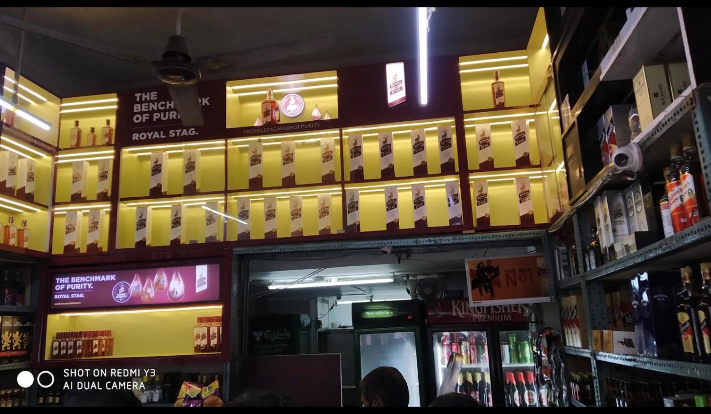 Stocked whisky, beer and spirits shelves at Vijay Wines on LBS Marg
