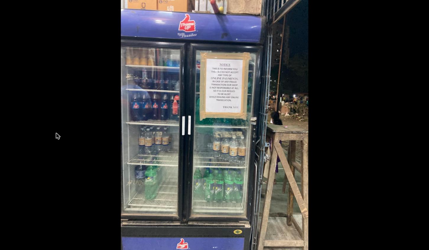 Chilled beverage fridge with soft drinks and water at Golden Wine & Beer Shop